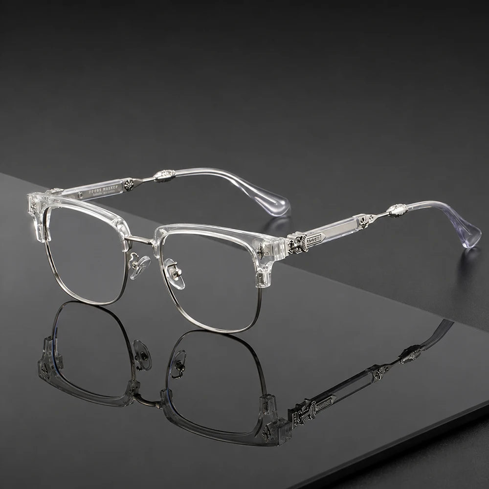 Lunettes vintage à demi-monture claires posées sur une surface sombre avec un reflet.