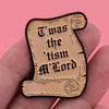 A gold-colored enamel pin featuring the text Was the tism M Lord in a decorative script on a black background.