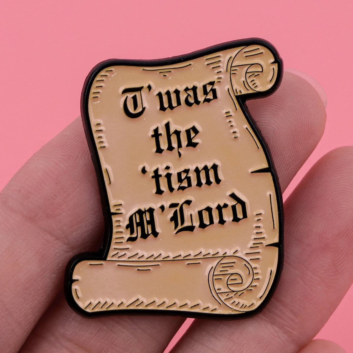 A gold-colored enamel pin featuring the text Was the tism M Lord in a decorative script on a black background.