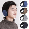 A person wearing dark gray clothing is shown next to several black and blue plush winter earmuffs.