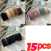 A collection of five colored elastic hair bands in various shades of pink, beige, and teal are displayed on a white plate.
