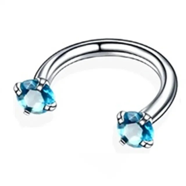 Silver stainless steel hoop earrings featuring blue crystal stones.