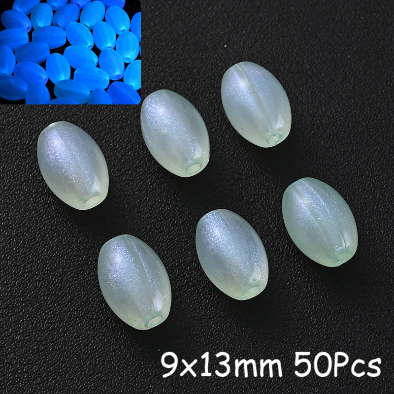 A collection of translucent, oval glow-in-the-dark acrylic beads on a black background.