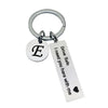 Silver keychain with a circular initial E and engraved text Drive Safe I need you here with me