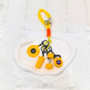A set of yellow fitness keychains and weightlifting accessories including a yellow dumbbell and various metal rings on a whit