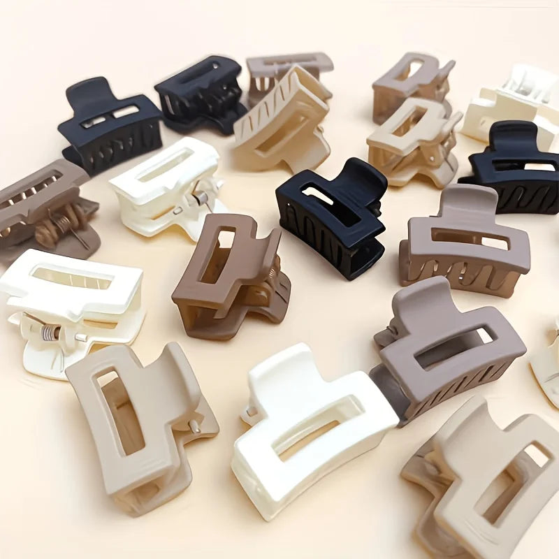 A collection of 12 rectangular hair clips in various shades of brown, beige, and black.