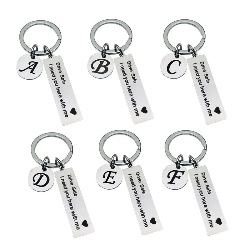 Six personalized initial drive safe keychains in black and silver metal.