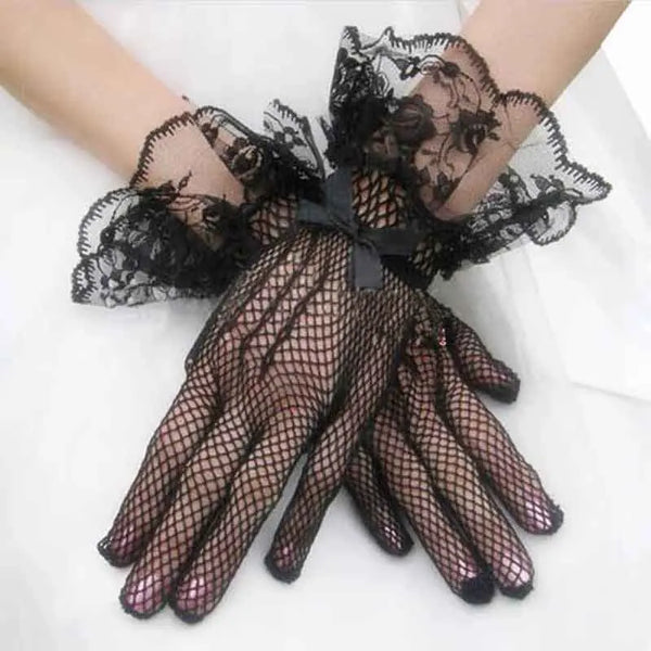 Black sheer lace fishnet evening gloves worn on a hand.