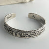 A sterling silver charm bracelet with engraved words and the number one on a white background.