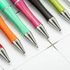 A collection of ten colorful beadable ballpoint pens arranged diagonally on a white surface.