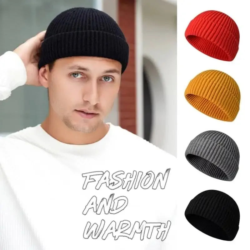 A man models a black knitted beanie cap alongside various colored knitted beanies.
