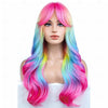 A woman modeling a long, vibrant rainbow ombre synthetic wig with bangs in pink, blue, and yellow hues.