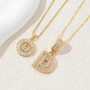 Gold initial letter necklace set featuring CZ crystal pendants for a couple