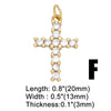 Gold plated cross charm with small clear stones, measuring 0.8 inches in length.