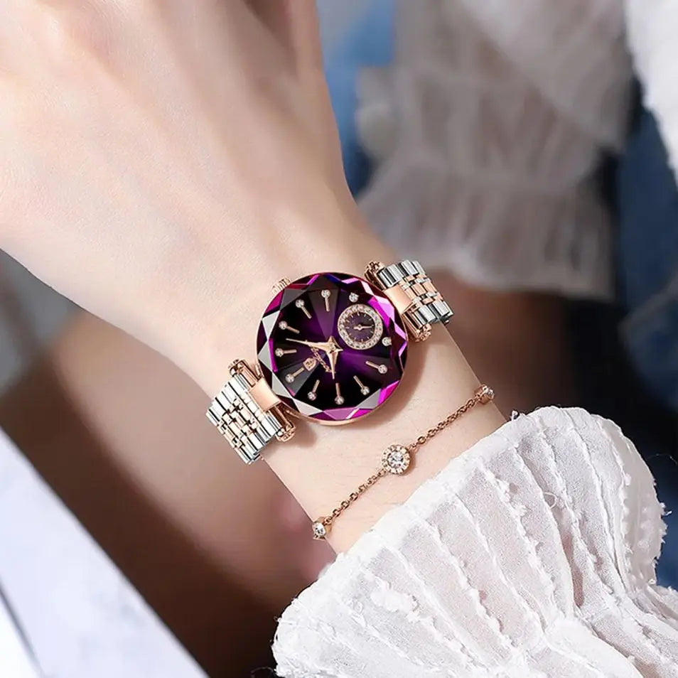 Elegant stainless steel quartz ladies wristwatch with a purple gemstone face and gold accents on a wrist.