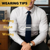 A man in a white shirt and dark tie sits, demonstrating wrong and right ways to wear a tie clip.