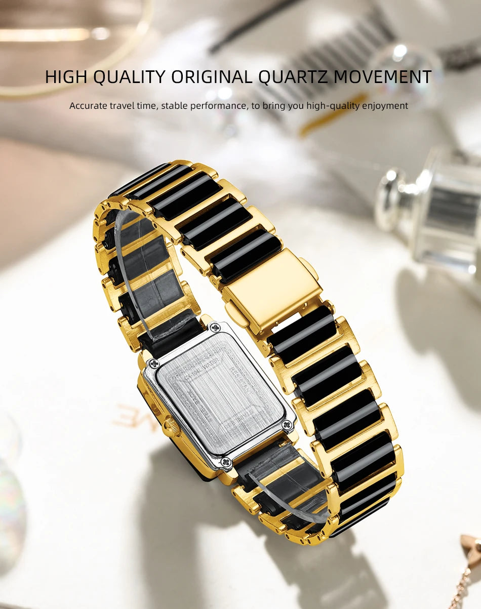 A close-up of a gold quartz movement watch with a black strap and silver case, displayed on a light background.