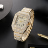 A gold-toned luxury men's quartz business watch with a diamond-encrusted bezel and bracelet on a dark background.