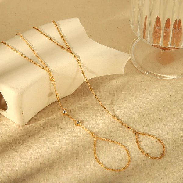 Gold plated stainless steel bracelet with zircon beads and a delicate chain, displayed on a light background.