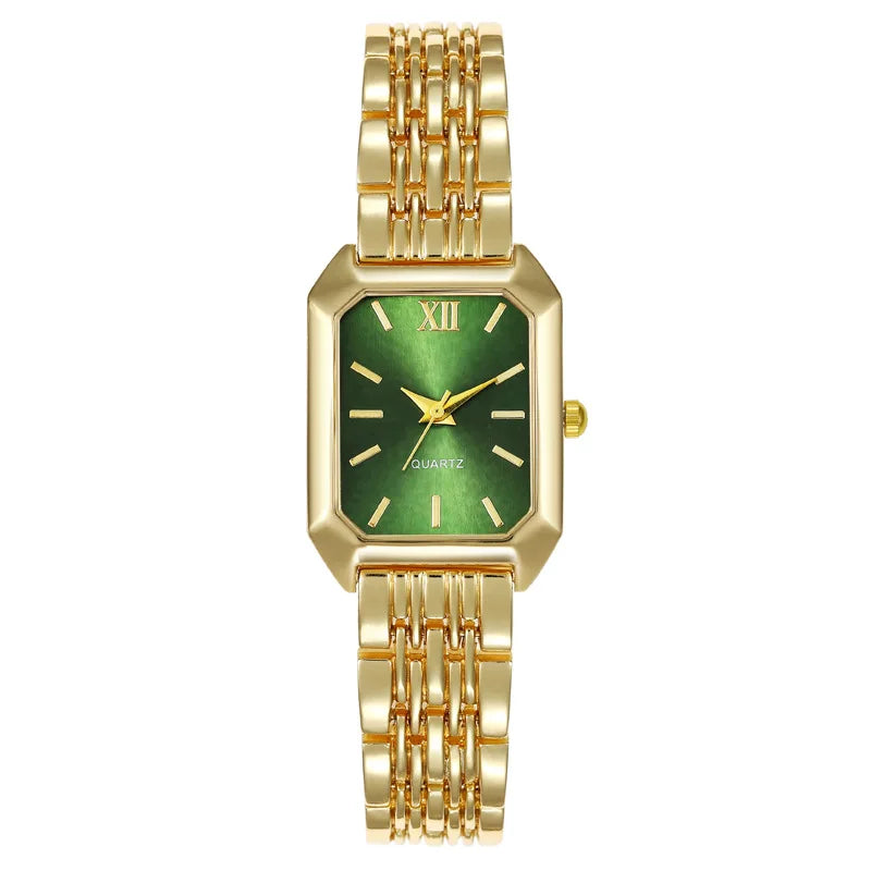 A gold minimalist quartz watch with a green dial and gold links on a white background.