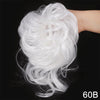 A close-up of white messy synthetic hair being styled on a hand.
