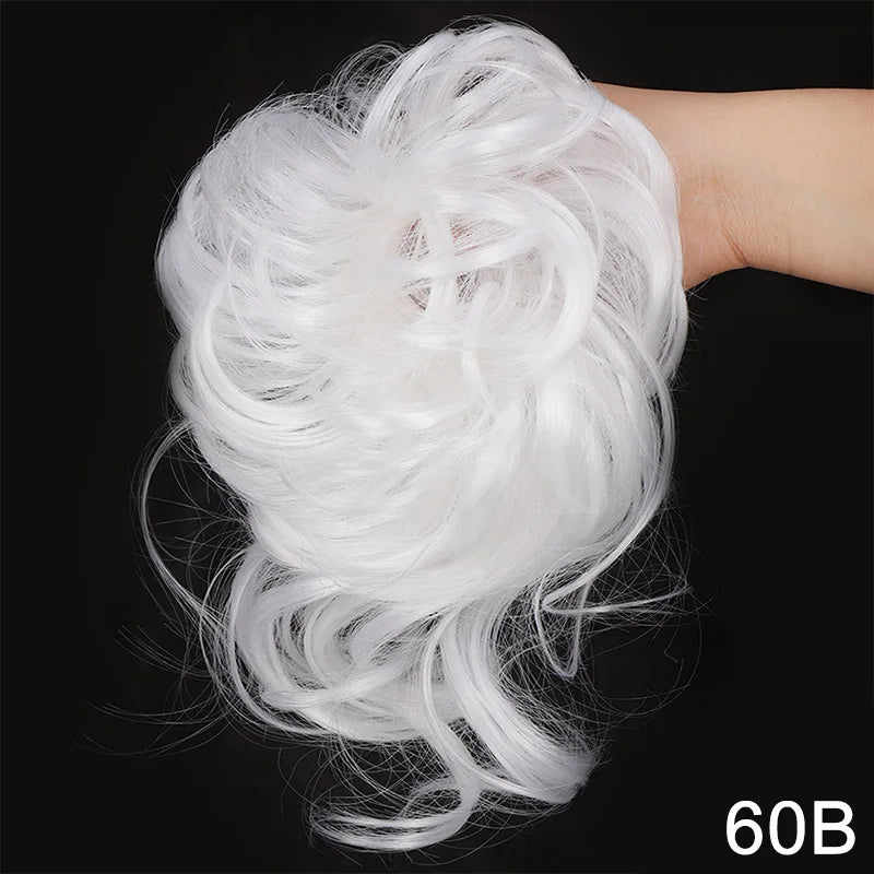 A close-up of white messy synthetic hair being styled on a hand.