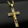 A gold-tone stainless steel cross pendant necklace with rhinestone accents displayed against a dark background.