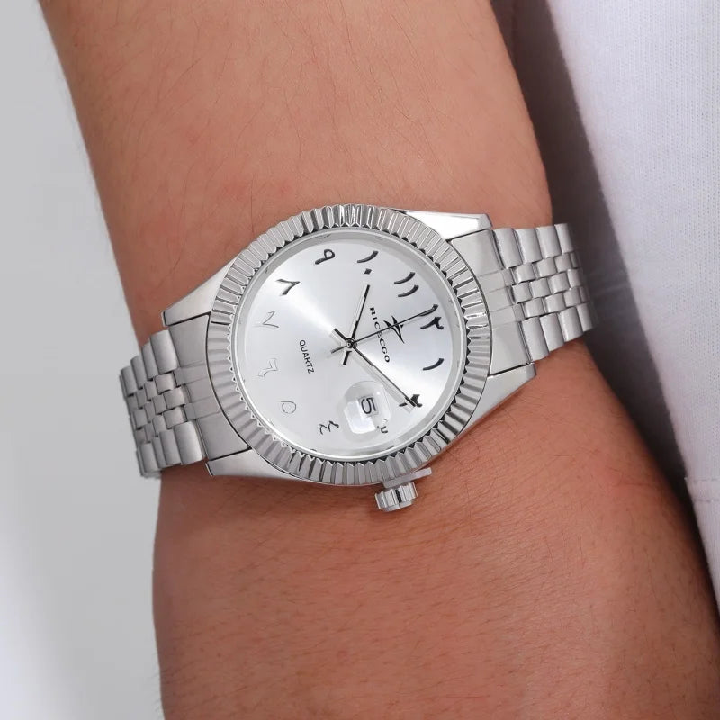 A silver luxury quartz men's wristwatch with a metal bracelet and date display worn on a wrist.