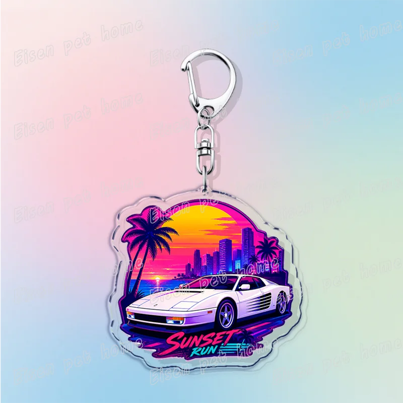 Silver pendant keychain featuring a silhouette of a sunset over a city skyline and palm trees.