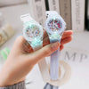 A hand holds a cute unicorn fashion watch for girls and women with a light blue strap and clear face.