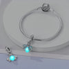 Sterling silver devil's eye charm bracelet with a glowing blue flower pendant