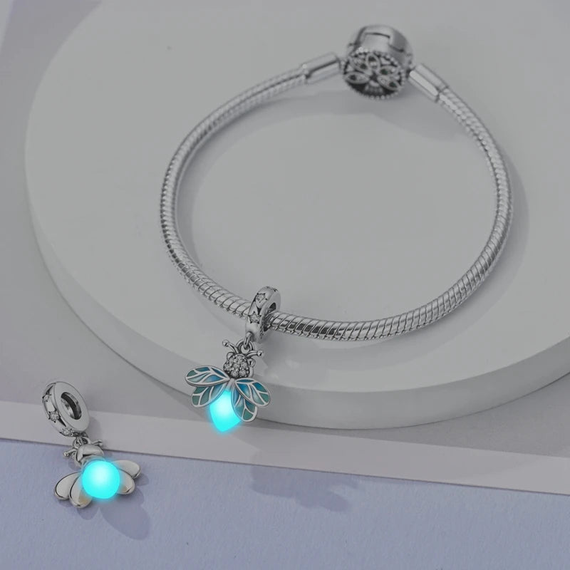 Sterling silver devil's eye charm bracelet with a glowing blue flower pendant