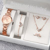 A box containing a rose gold quartz wrist watch, a necklace, and several small diamond-like jewelry pieces.