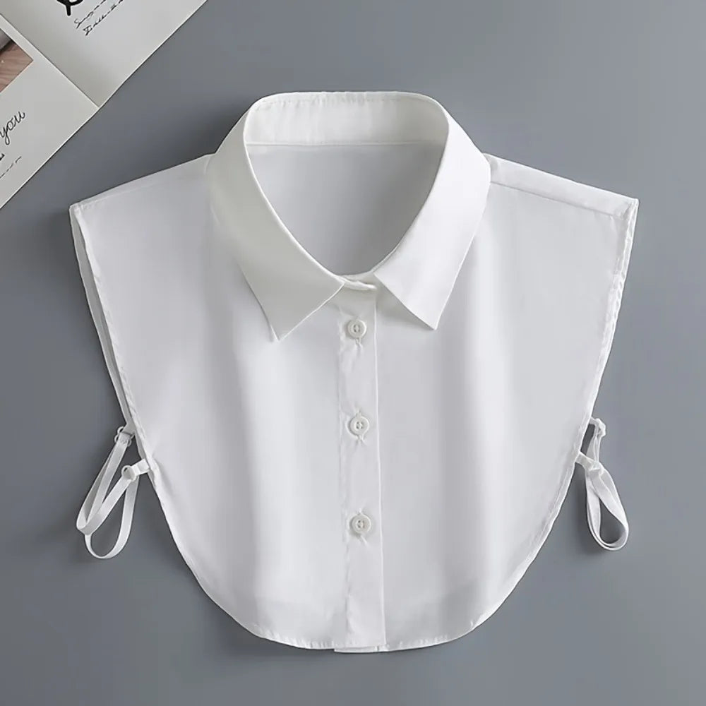 A white elegant detachable button-up collar shirt displayed flat on a gray surface.