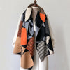 A luxury plaid cashmere feel scarf and shawl wrap featuring geometric patterns in black, orange, beige, and white.