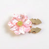 A pink, pearlescent flower button cover with a gold glitter center and two gold butterfly-shaped buttons.