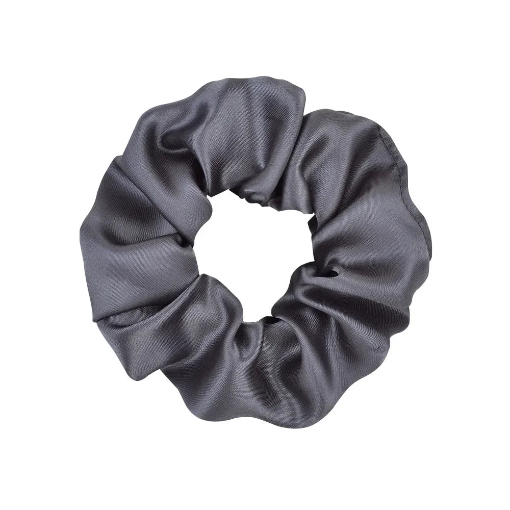 A dark gray satin scrunchie tied in a loop.