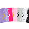 A row of colorful satin drawstring bags for storing wigs and hair extensions in purple, pink, green, and black.