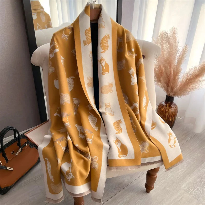 A yellow and cream luxury plaid cashmere feel scarf and shawl wrap displayed on a white chair.