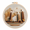 A circular embroidery kit featuring a depiction of a nativity scene with figures and landscape.