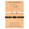 Two bracelets, one white and one black, featuring a love knot design.