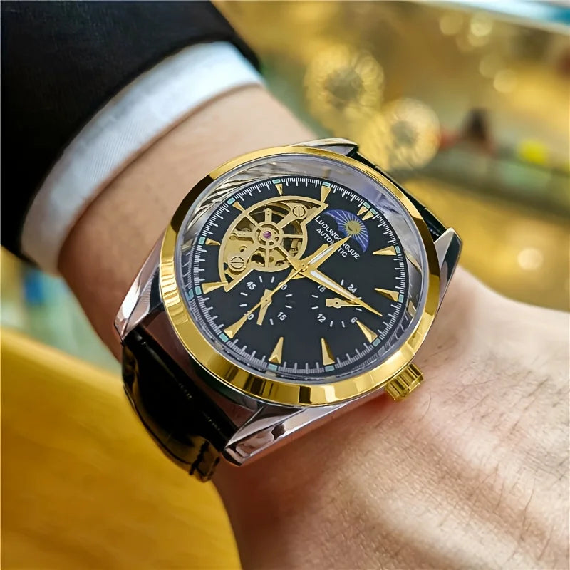 A close-up of a gold-toned luxury automatic mechanical men's wristwatch worn on a wrist.