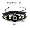 Black braided bracelet with a silver sun charm and black cord.
