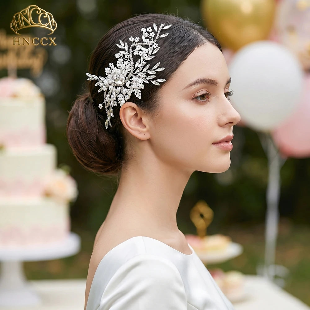 A close-up profile photo of a woman wearing a rhinestone bridal headband with flowers, looking to the right.