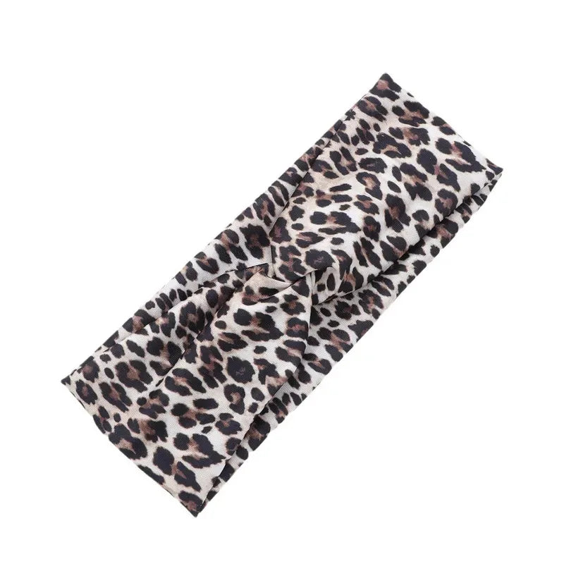A close-up of a black and tan leopard print fabric used for fashion headbands.