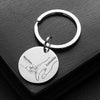 A silver stainless steel keychain featuring a handprint design with the names Martina and Antonio.