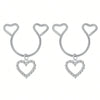 A pair of silver heart dangle non-piercing nipple rings adorned with cubic zirconia stones.