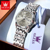 A stainless steel watch with a silver dial and luminous markers is displayed in a box with a white tag.