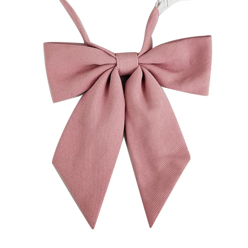 A pink ribbed butterfly ribbon tie set with a bow, suitable for students.