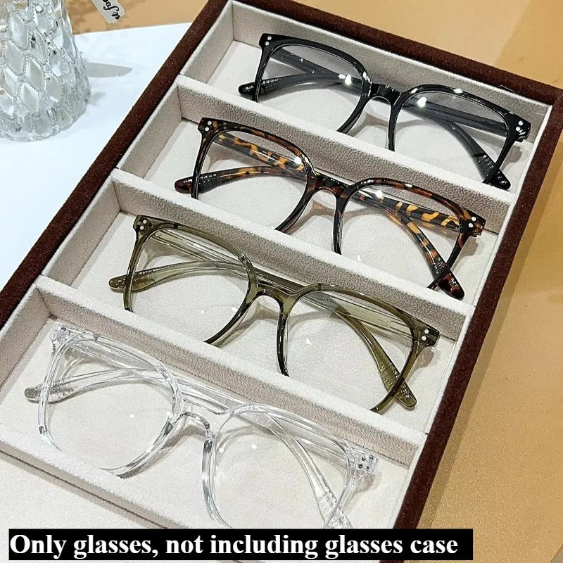 A set of four classic square anti-blue light eyeglasses displayed in an open box.